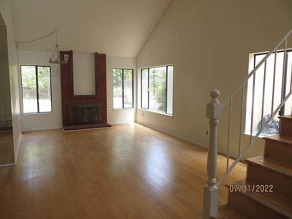 Living room with abundant natural light and vaulted ceiling