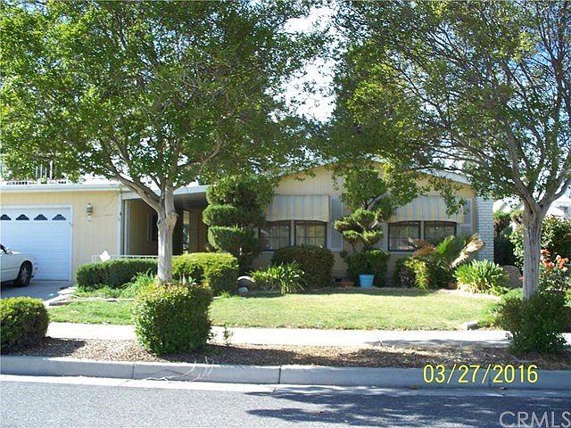 Curbside view, sunroof over garage, property backs up to Seven Hills golf course