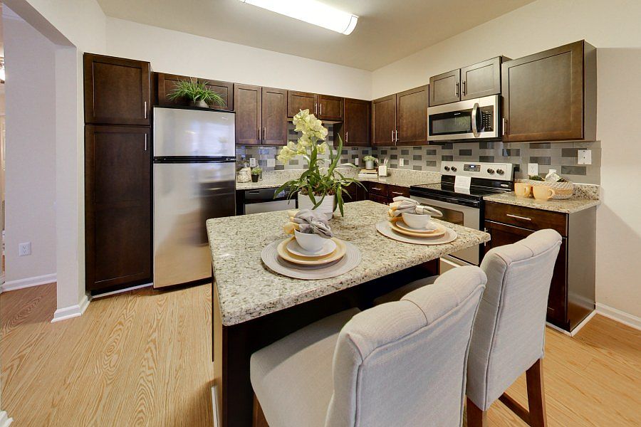 Upgraded kitchens with stainless steel appliances and subway tile backsplashes