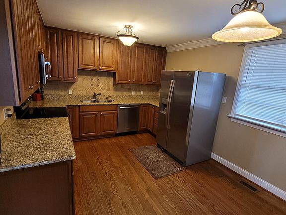 Kitchen with stainless refrig & dishwasher.