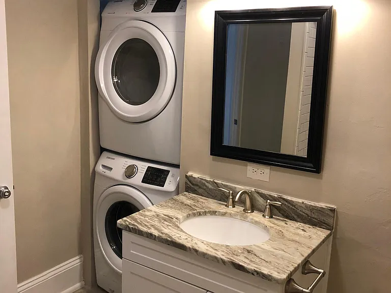 Washer and dryer off bathroom