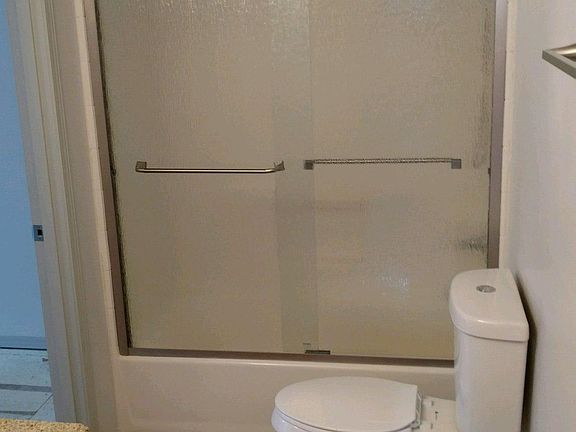 New shower door and new toilets and Koehler bath cabinet