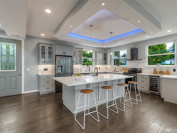 Hardwood flooring throughout, pantry, double sided island cabinets, wine/beverage refrigerator. 