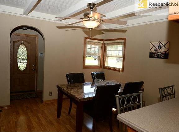 Front entry with beautiful front door and dining room.