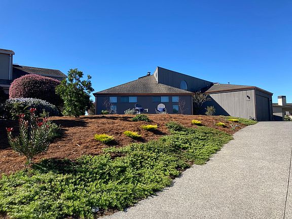 Updated driveway with landscaped entrance and view from the street.