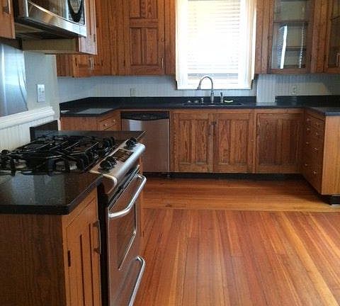 Spacious granite and stainless kitchen with original wooden