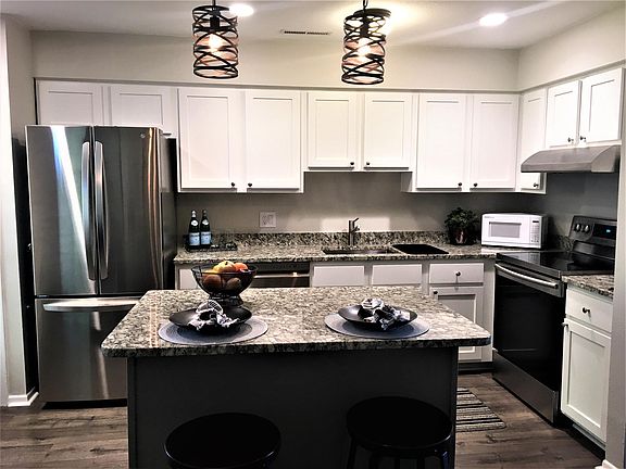 newly remodeled kitchen, granite countertops, new appliances, new cupboards.