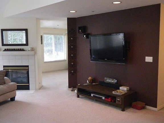 Standing at front door looking at living room with 2 sided fireplace.