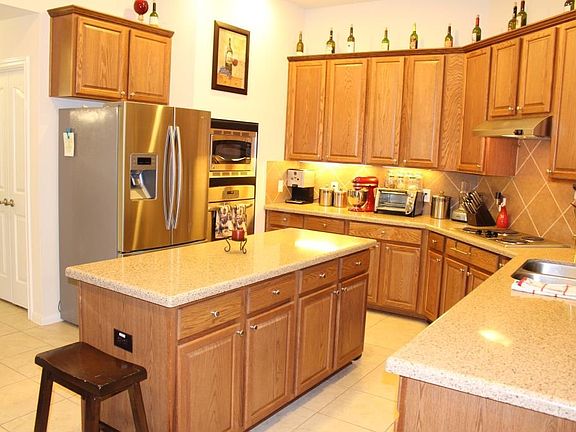 The cook will love this kitchen. There are lots of cabinets to store all of your things.