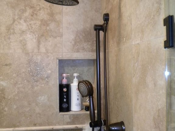 Tumbled marble and travertine master shower
