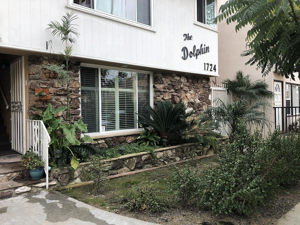 This is the front of the friendly 12 unit building. The photo features the front door and the front living room window with plantation shutters.