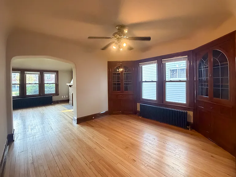 Dining room with good windows, built in cabinets, wood floors, and refinished woodwork.