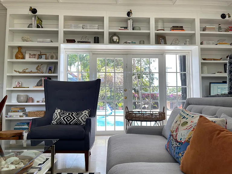 Family room with wrap around built -in bookcases.