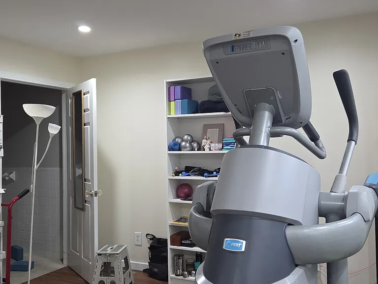 1st floor gym. The boxes on the left will eventually be removed. The door on the left is a fully wheel-chair-accessible bathroom with roll-in shower.