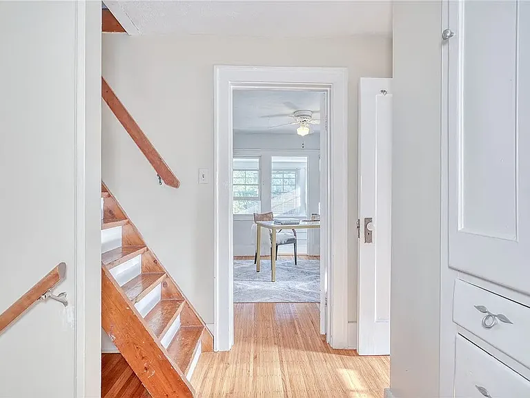 More built-in cabinets for linens and a stairway to the attic/loft.