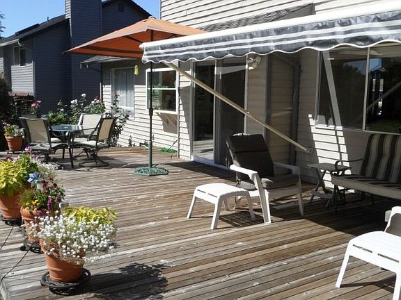 Relax on your beveled cedar deck.  Just seal it every year with Thompson's water seal to keep it looking great.  The Sunsetter Sunshade provides comfort from the southern sun for you & protects your carpet & drapes from fading too!