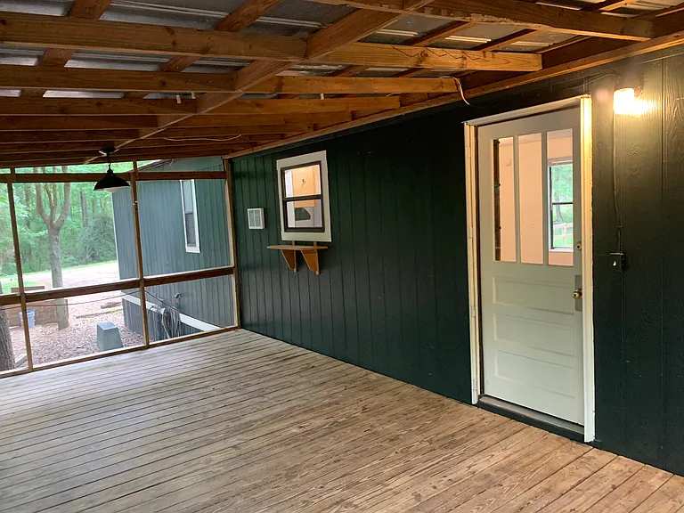 Inside screened in porch. Front door entrance.