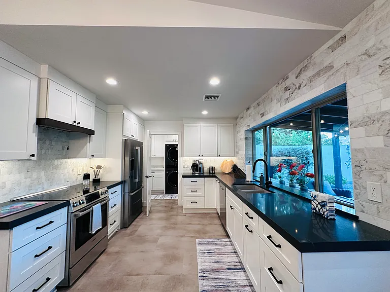 Chef's Kitchen: 
Fully equipped with everything you need to prepare a nice meal, featuring quartz countertops, a coffee maker, and a massive center island perfect for meal prep and casual entertaining.