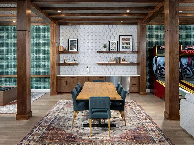 Community Lounge Featuring Shared Table, Kitchenette, and Game Area with Skee-Ball