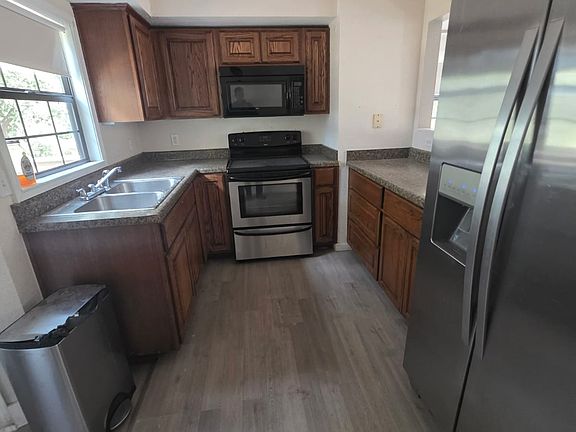 Fridge, microwave, range in kitchen