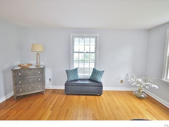 Freshly painted living room overlooks expansive front porch.