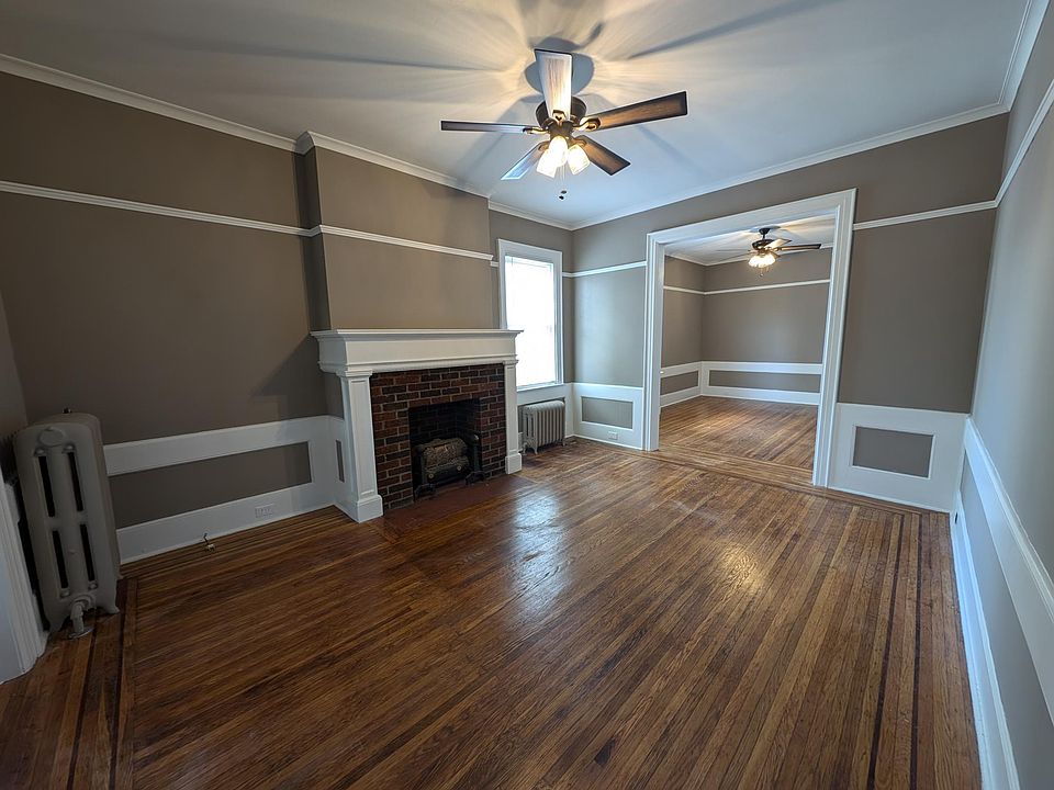 Front Entry into Apartment w decorative fireplace and ceiling fan