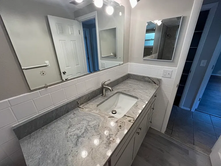 Granite countertop is beautiful in this shared bathroom