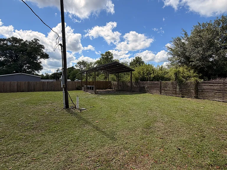 Huge fenced in backyard with pole barn