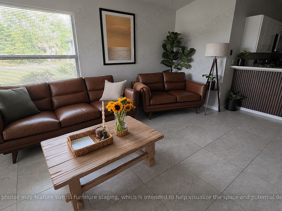 Experience airy, open-concept living in this expansive room bathed in natural light. The seamless transition between spaces and bright, clean aesthetic create a welcoming atmosphere that feels both modern and incredibly comfortable style