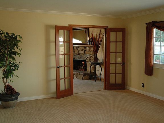spacious living room with nice view of pool and backyard