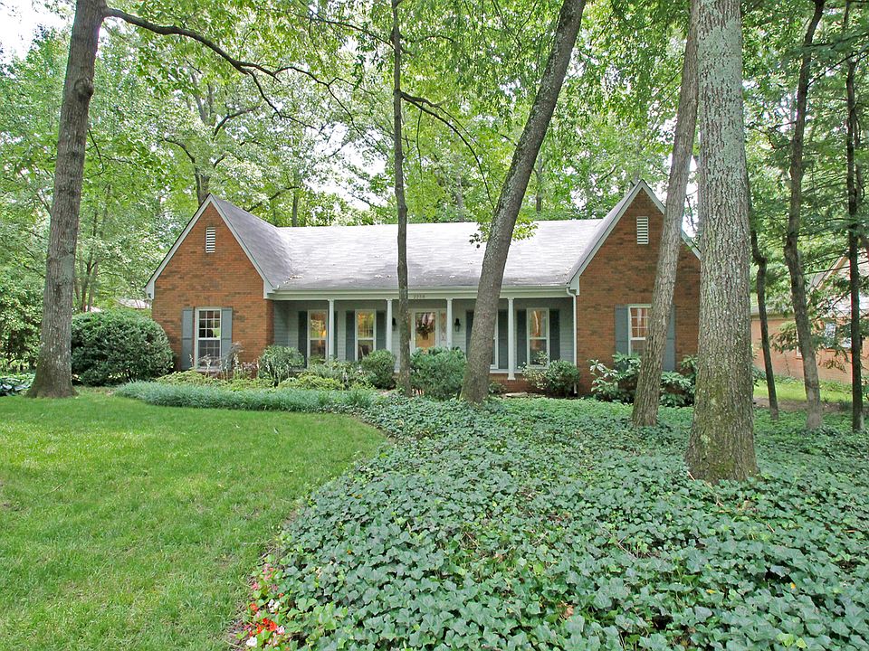 wooded lot & brick porch