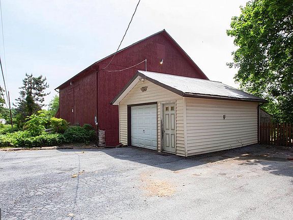 Detached garage with bank Barn behind