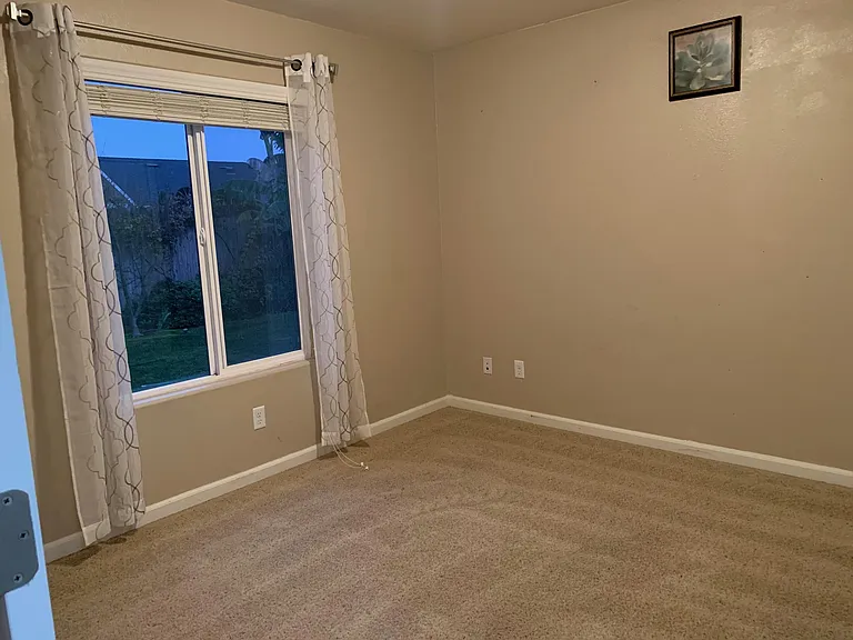 Guest bedroom 1 with a nice view of hew of the backyard