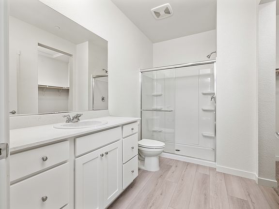 The master bathroom has a large vanity and a step in shower!
