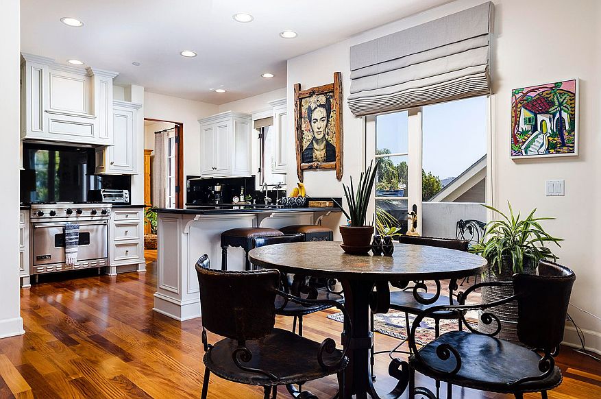 Kitchen with Black Granite Counter Tops, Breakfast Bar, and Viking appliances. Dining area and View Balcony with Fountain.