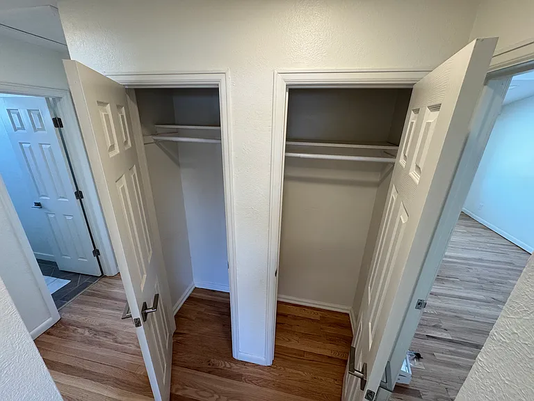 Linen closets in hallway between master bedroom (right side) and other two bedrooms and bathroom