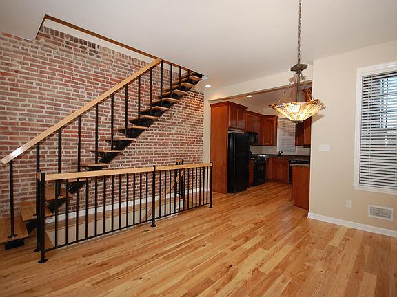 Dining room (open floorplan) with exposed brick wall