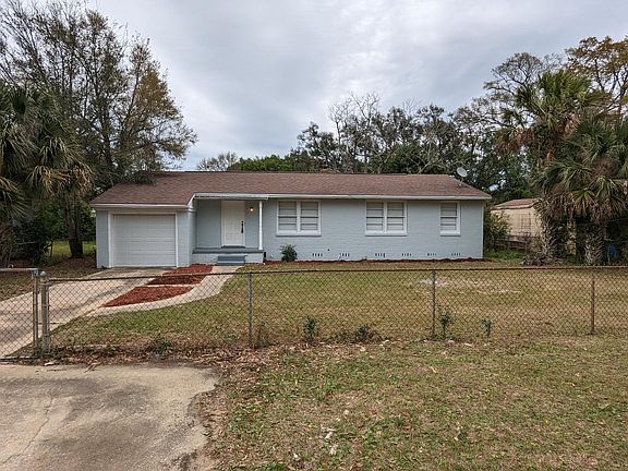 A view of the driveway and front yard