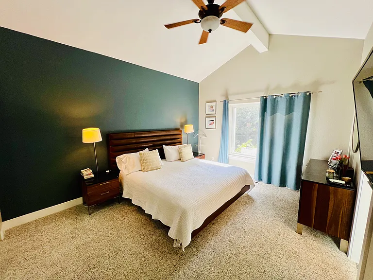 Primary bedroom with ensuite bathroom. The windows face the outdoor patio.