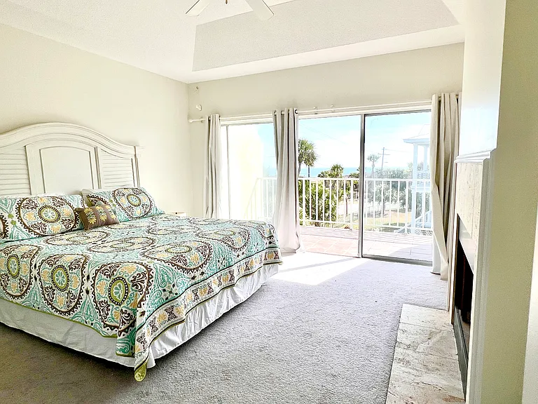 King bed in primary bedroom. Ocean view balcony, attached bath, trey ceilings, non working fire place