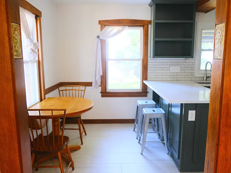 Bright, modern eat-in kitchen with adjacent cozy dining table for casual meals, entertaining or work from home space.