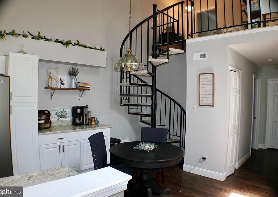 Eating area with staircase leading up to loft and third bedroom