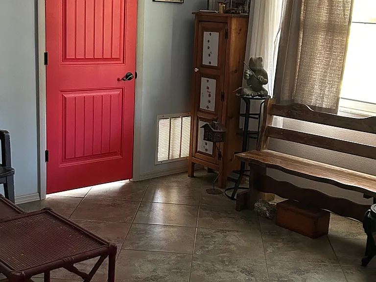 The red door in the living room. The main entrance to the house is on the other side.