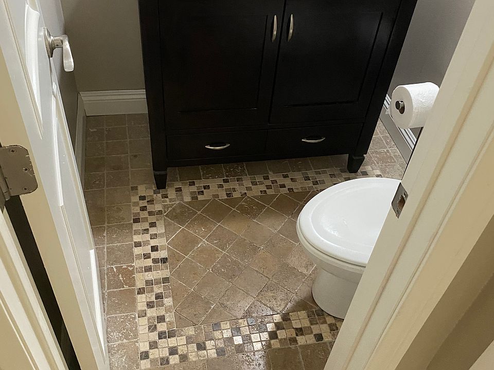 Down Stairs half bath showing custom flooring.