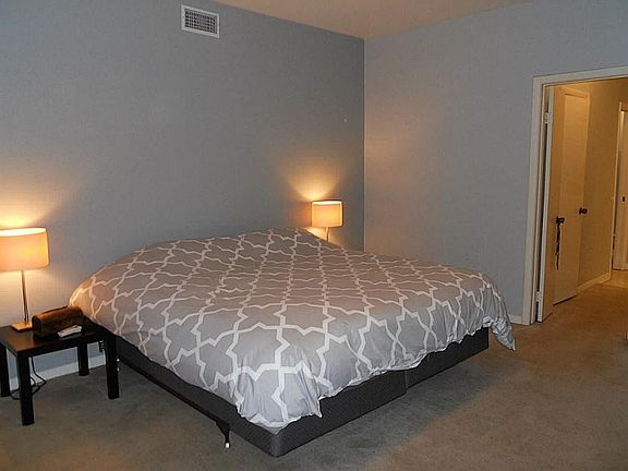 Master Bedroom with view toward on suite bath with left and right walk-in closets.