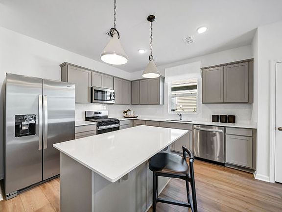 Discover the modern elegance in the kitchen with sleek grey cabinets.