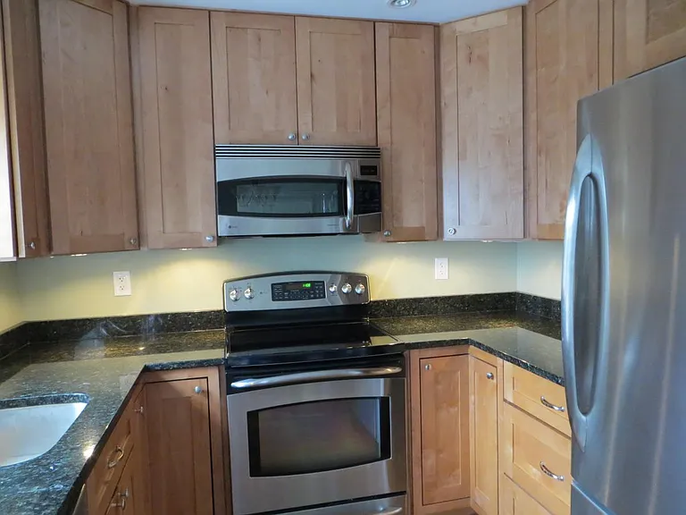 Fully remodeled kitchen features 42" custom cabinets, stainless steel appliances, and granite counters