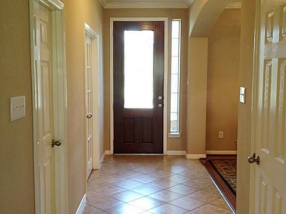  A handsome wood door and wide entry space welcome your guests.