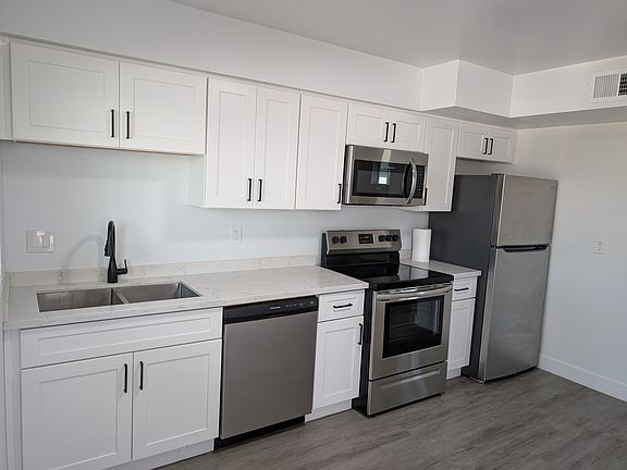 Renovated kitchen with stainless appliances.