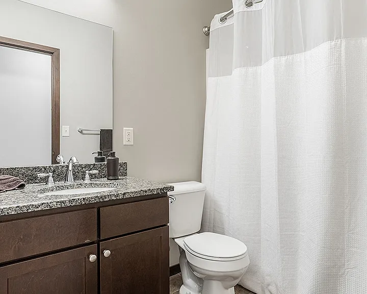 Spacious bathroom with granite countertops.